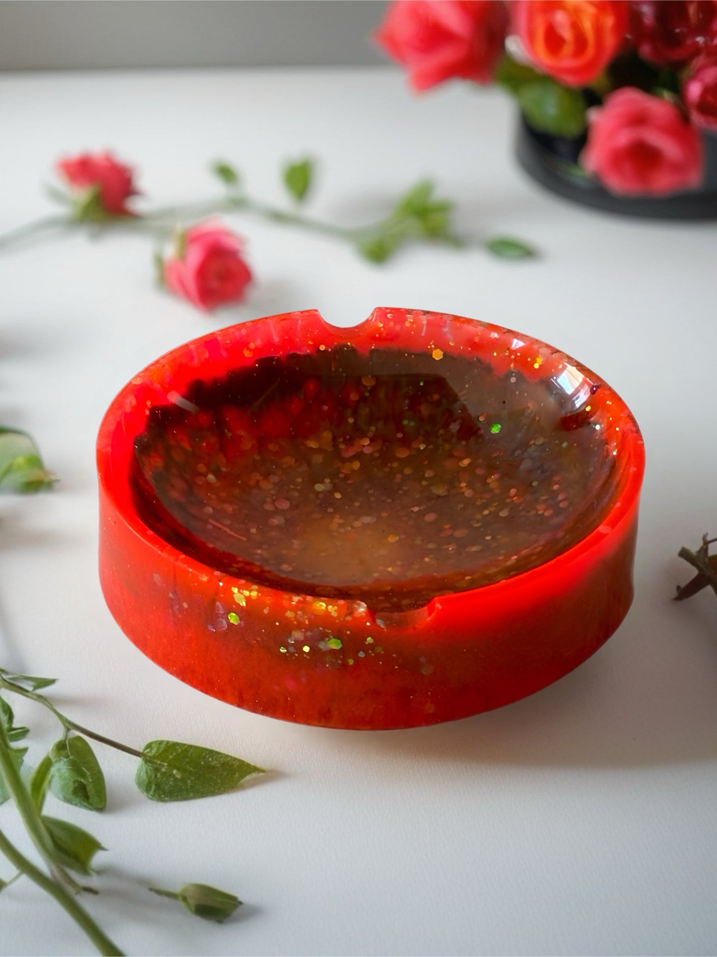 Neon pink and orange resin ring dish with green shimmer